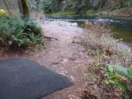 Paved trail transitions on to natural surface – rocks on the ground –  transition is uneven – Salmon River